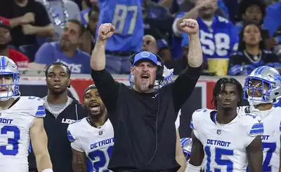 The Detroit Lions celebrate as head coach Dan Campbell is named the 2024 NFL Coach of the Year and the team achieves a historic victory.